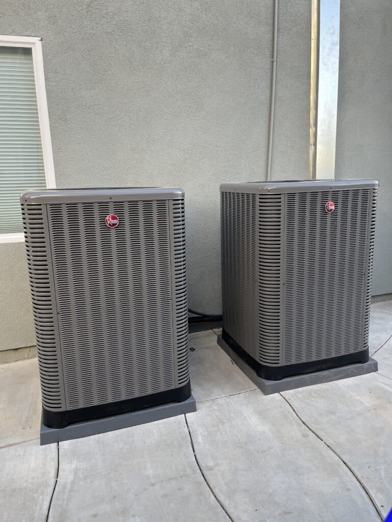 two Rheem brand air condition units