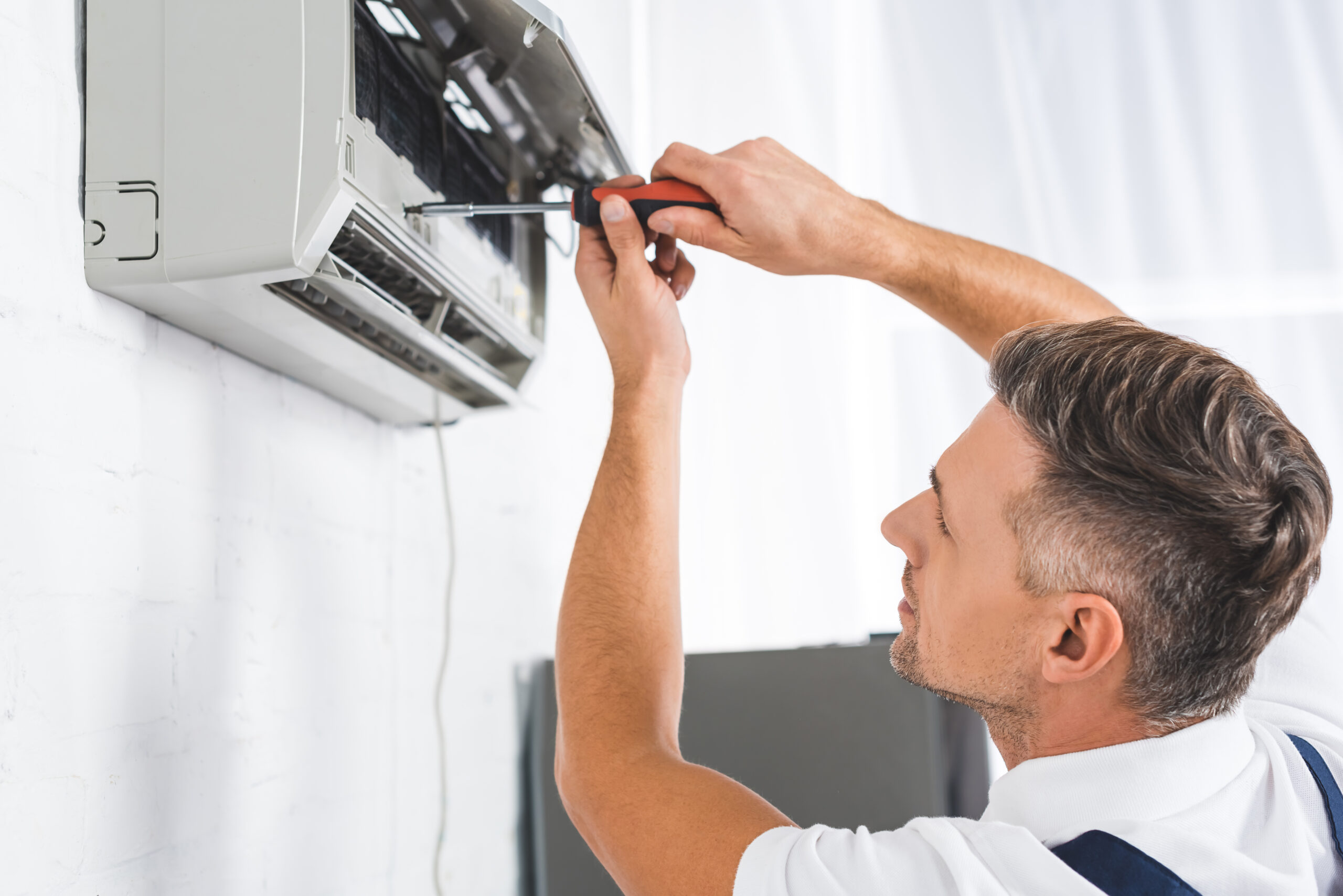 Man fixing an air conditioning unit